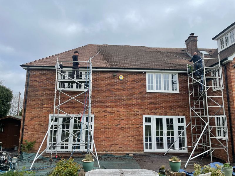 Roof cleaning carried out safely from scaffold towers by The Roof Moss Cleaners in Crawley